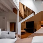 An Italian Penthouse Shines With Colored Mirrors in Forlì