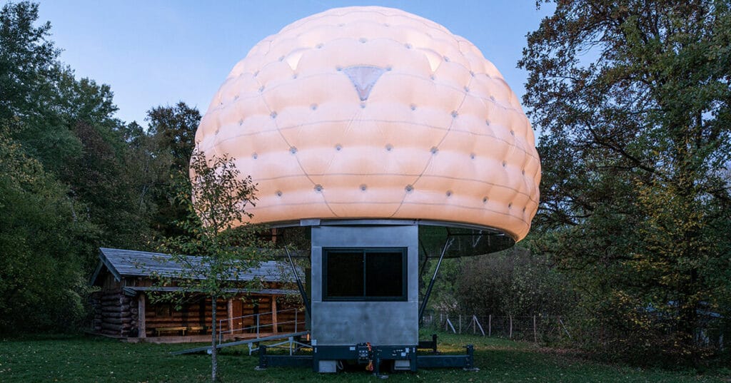 mobile sleeping hut combines stainless steel trailer with double-shell inflatable dome