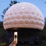 mobile sleeping hut combines stainless steel trailer with double-shell inflatable dome