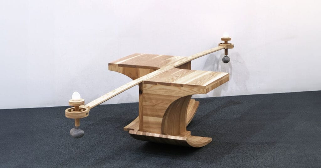 halfway serious wooden chair transforms sitting into a performative act of balance