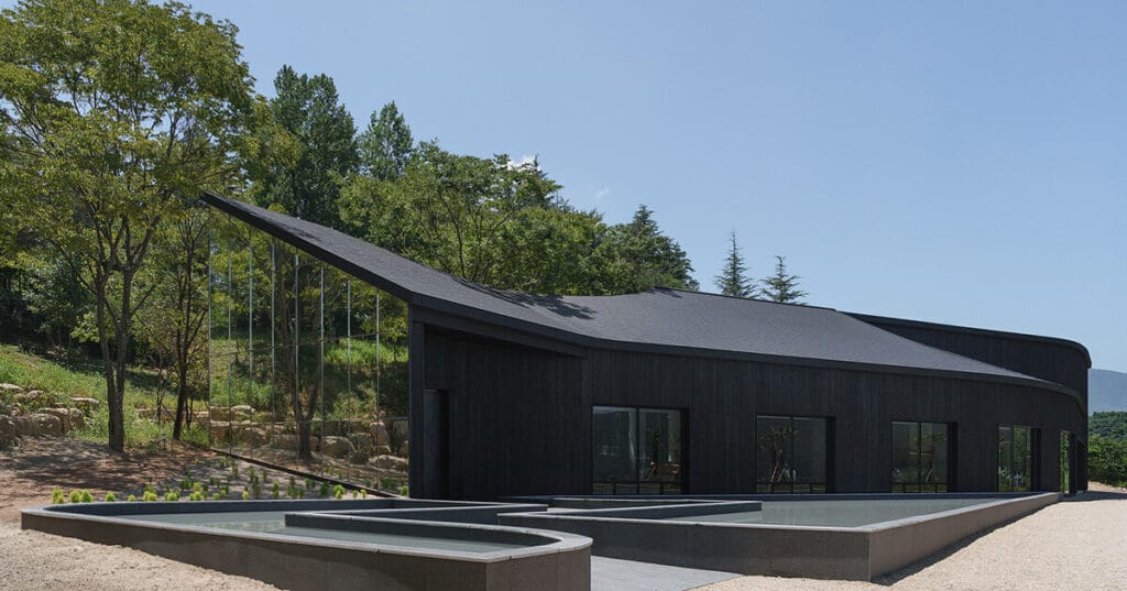 mirrored facades of ‘tan-mok-won’ korean bakery dissolve into healing landscape