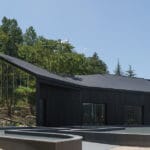 mirrored facades of ‘tan-mok-won’ korean bakery dissolve into healing landscape