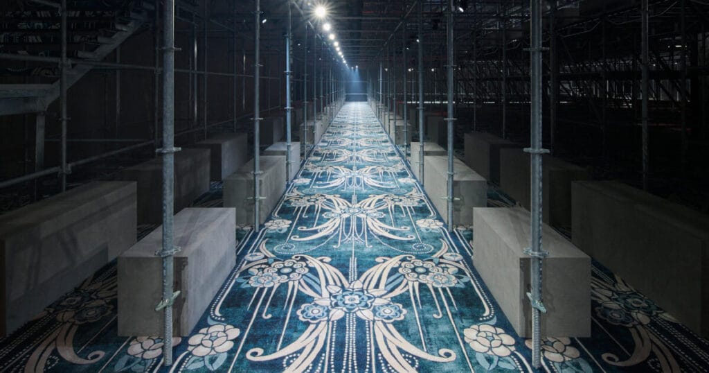 AMO surrounds prada FW25 set design with scaffolding structures