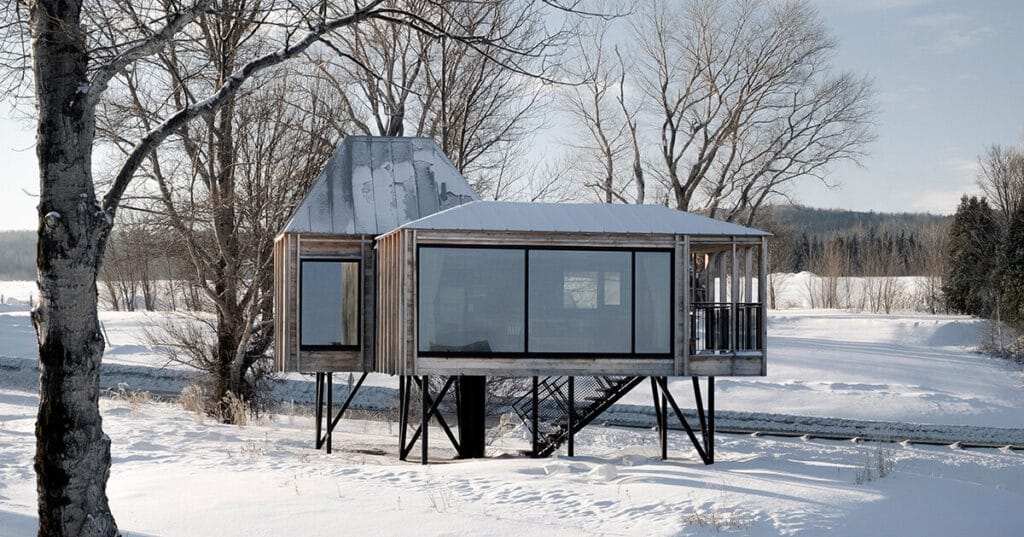 prefab residence by delordinaire balances on stilts to preserve natural terrain in quebec