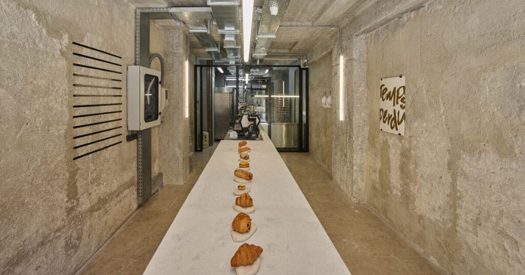 transparent facade reveals bakery’s raw industrial interiors by saint of athens