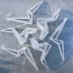 white flame installation’s sharp geometry resembles ice crystals along lake in china