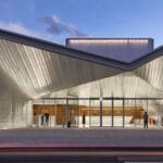 teatro borsoni unfolds sculptural geometric facade in italy
