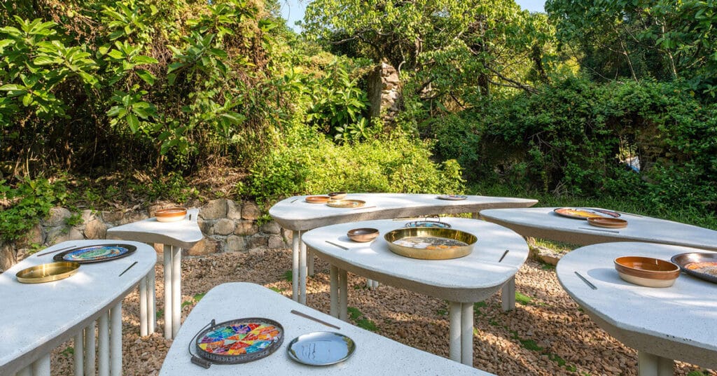 AI illustrations of dishes adorn vibrant mosaic plates for dining table installation
