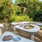 AI illustrations of dishes adorn vibrant mosaic plates for dining table installation