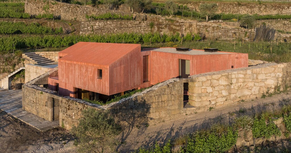 ancient wall envelops pink house by stefano riva in portugal