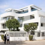 sculptural ribbon-like volumes compose dual residence in athens