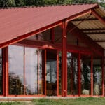 dwellings cluster beneath sigurd larsen’s red barn