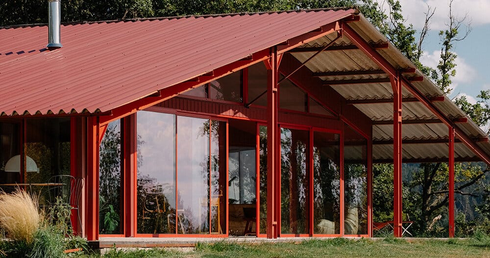 dwellings cluster beneath sigurd larsen’s red barn