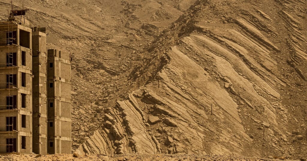 architecture contrasts against natural rock formations in manuel álvarez diestro’s photo series