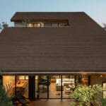 cut-out sloped roof covers three-layered residence in thailand