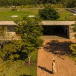 stone volumes compose residence by studio MK27 under continuous overhang in são paulo